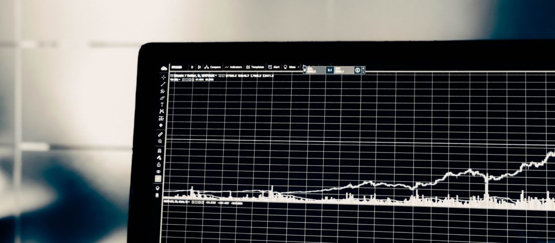 laptop screen displays stock market data